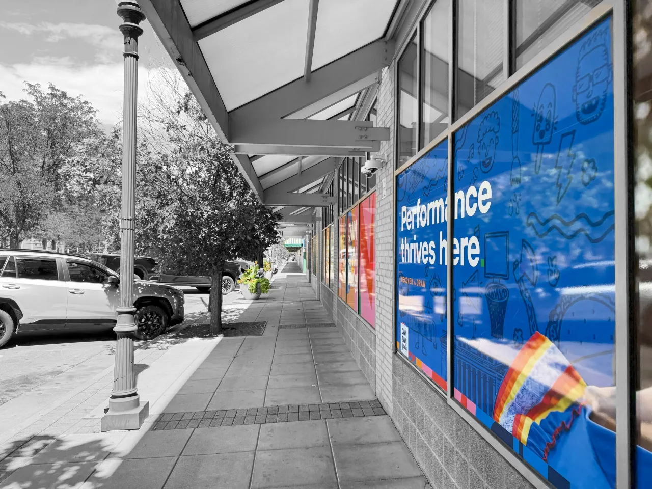 Windows of shops with the saying "Performance Thrives Here"